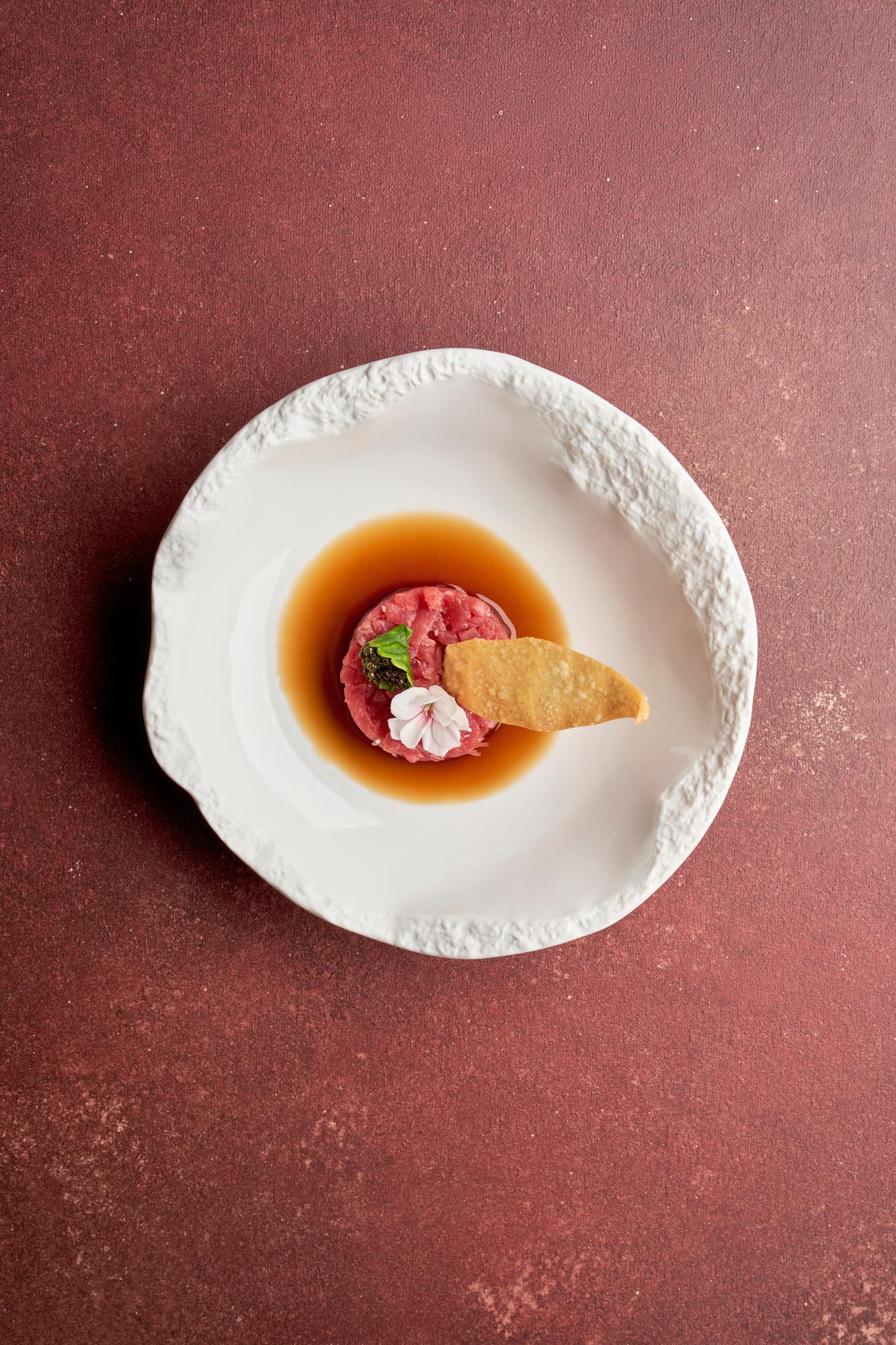Close-up gourmet plated course with textured sauce